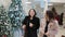 Two women choose the scenery for the Christmas store Christmas decorations.