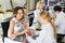 Two women clients having manicure done in nail salon