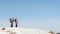 two women climbed to the top of the mountain during a winter hike