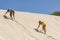 Two women climbing sand dune Cape Verde