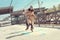 Two women in coats jump and play hopscotch on the pavement.