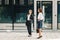 Two women colleagues standing at the office