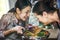 Two women cooking healthy vegetables in a pan