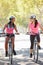 Two Women Cycling On Suburban Street