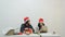 Two women decorate gifts with ribbons for Christmas, New Year.