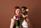 Two women of different races with flowers in their hairs holding bouquets. Caucasian and African American females looking at