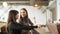 Two women discuss the menu and choose food in a cafe standing at the bar counter.