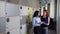 Two women discuss something in office near storage cells.