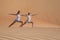 Two women doing yoga in the desert.