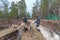 Two women feed reindeer, Sami, saami village on the Kola Peninsula, Russia. Tourist ethnographic parking. Settlement Old Titovka,