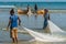 Two women with fishernet at the coastline from Morondava fishing