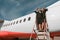 Two Women flight attendant standing on airplane stairs at airport and looking away before flight