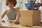 Two Women Friends Running Online Fashion Business Packing Order Of Denim Jeans Up Into Box 