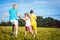 Two women and girl playful on a summer meadow