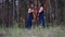 Two women harpists go towards each other at forest and play harps.
