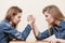 Two women having arm wrestling fight