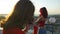 Two women having photo session with smartphone on the rooftop