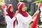 Two women hijab smiled while putting on Indonesian flags and their headbands