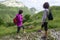 Two women hikers walking in the mountains