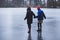 two women holding hands on the ice