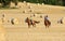 Two Women Horseback Riding in a Field