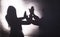 Two women join hands in shadow play