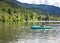 Two women Kayaking on a pristine mountain lake in the state of Washington Pacific Northwest.