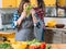 Two women kitchen cooking mother smelling lettuce