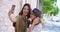 Two women making a selfie in rural town.Young women smiling happy portrait. Front view, close-up.Women looking at