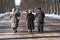 Two women and a man enjoying pole walking in the park in early spring