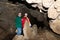 Two women, members of the tourist group, pose against the backdrop of the cave. Red Cave