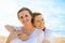 Two women mother and adult daughter enjoying vacation on the beach