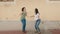 Two women mother and daughter smiling confident jumping at street