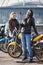 Two women motorcyclists making photo with selfie stick and front camera of cellular