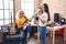 Two women musicians singing song playing electrical guitar at music studio