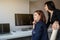 two women in office outfit working on computers and discussing a report