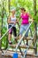 Two women, one pregnant, at fitness sport in climbing park