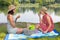 Two women picknick at water side