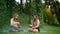 Two Women practice yoga with standing or resting bell, singing bowl in park