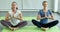 Two women practicing basic yoga together in calm and concentrate pose