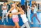 Two women practicing palm strike in sparring in gym