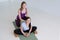 Two women practicing yoga, doing Butterfly exercise, baddha konasana with props