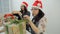 Two women prepare new year presents for Christmas holidays inside