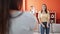 Two women recording video dancing at home