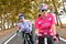 Two women ride bike