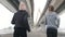 Two women running under the bridge