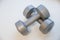 Two women`s dumbbells on white background.Healthy shape and sport concept. Shaping and fitness equipment. Dumbbells made