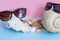 Two women`s and men`s sunglasses over large seashells and severa