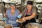 Two women serve roasted pig, Ecuador