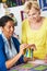 Two Women Sewing Quilt Together